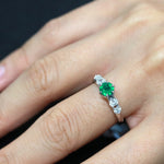 dainty emerald diamond ring modeled