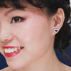little blue sapphire heart diamond earrings modeled