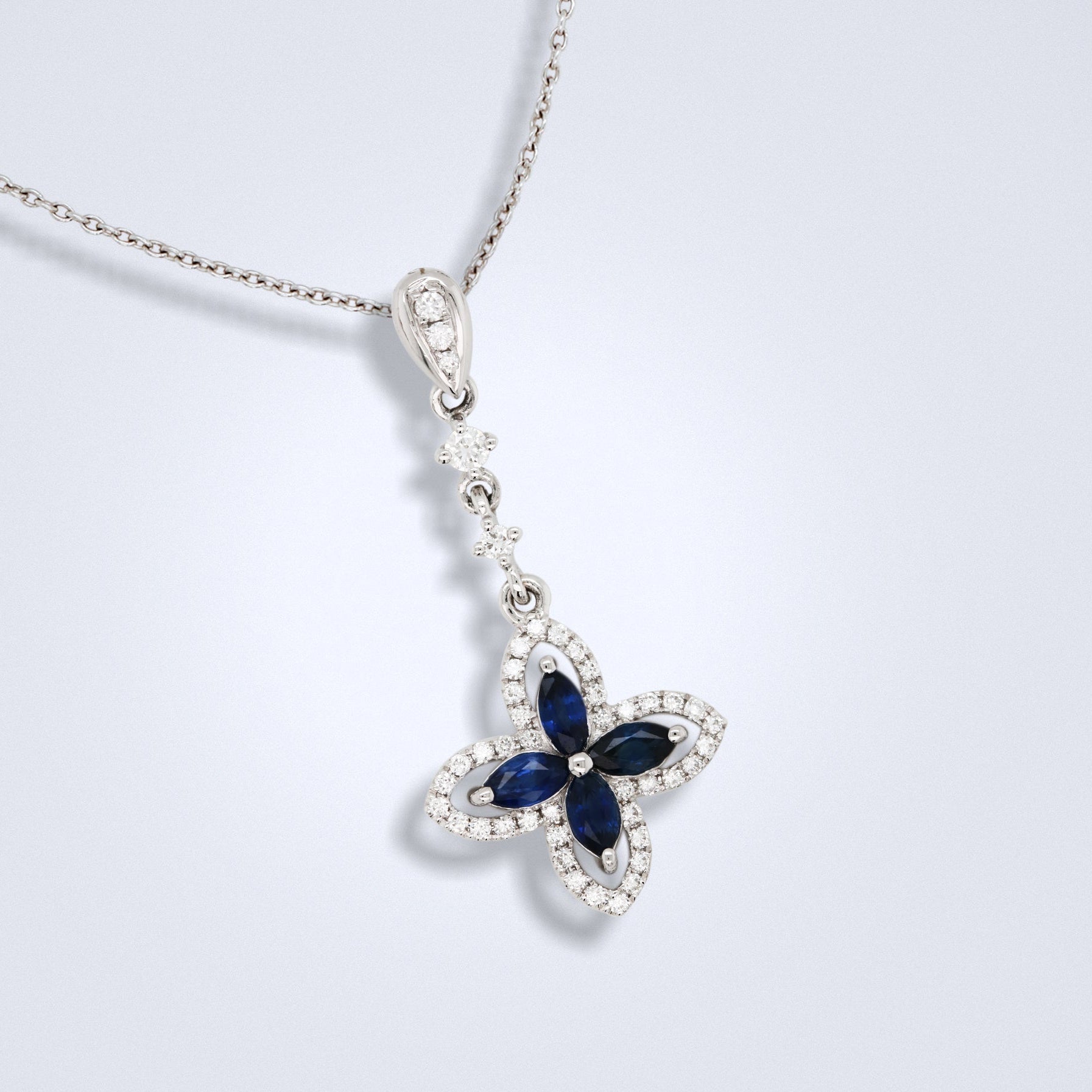 blue sapphire diamond pendant in an ixora shape design