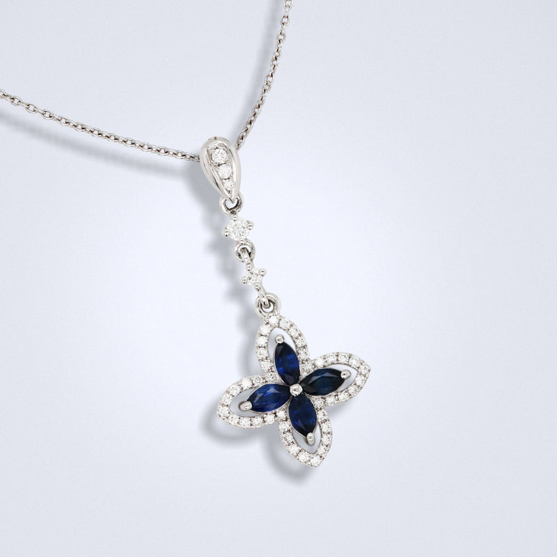 blue sapphire diamond pendant in an ixora shape design