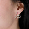 flow diamond earrings modeled