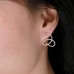 flow diamond earrings modeled