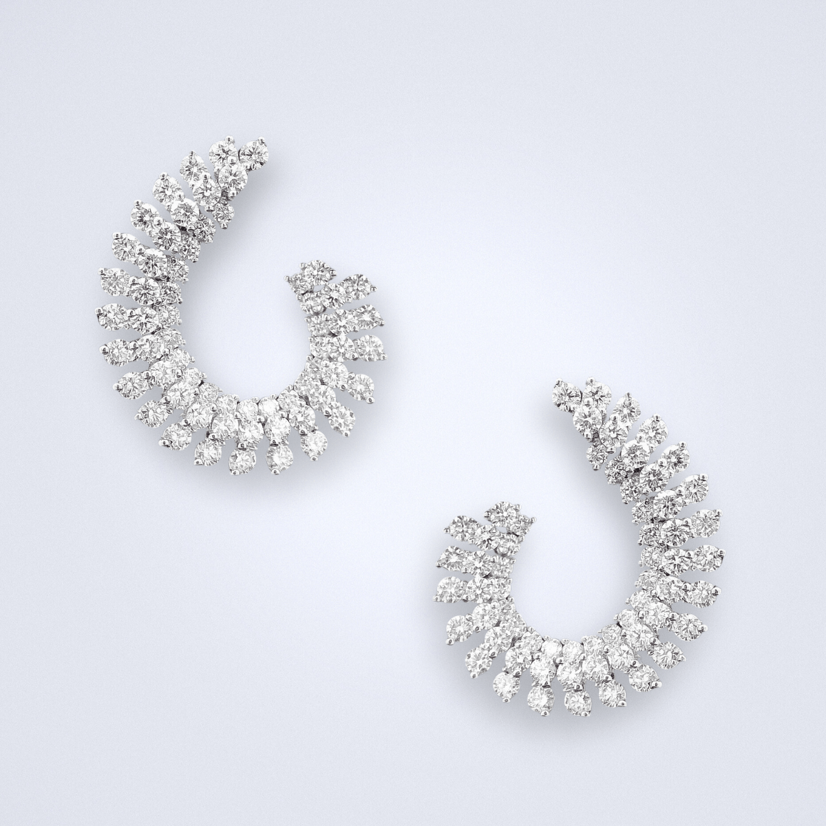 Nebula Diamond Earrings - Benny's Gems Creations 18K White gold diamond earrings in a spiral like shape 