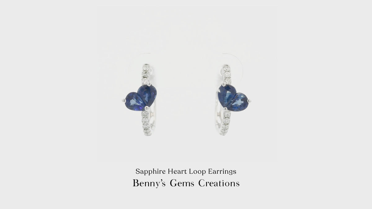 Sapphire Heart Loop Earrings featuring vibrant blue heart-shaped sapphires set in elegant looping design, accented with sparkling diamonds in white gold