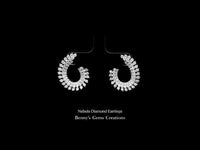 Fancy diamond earrings with brilliant round diamonds in a modern celestial-inspired design, elegant and radiant fine jewelry piece