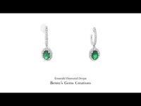 18K white gold emerald and diamond earrings featuring 2 emeralds (1.47 ct total) and 44 diamonds (0.87 ct total).