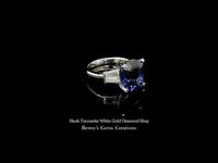 Sleek diamond ring with vivid blue tanzanite center stone crafted in a slim, polished setting.