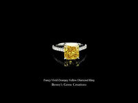 Fancy vivid orangey yellow diamond ring showcasing intense color and exquisite brilliance