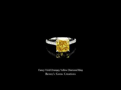 Fancy vivid orangey yellow diamond ring showcasing intense color and exquisite brilliance